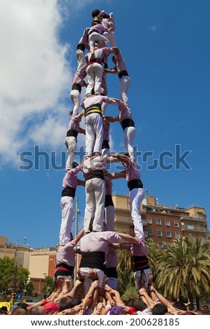 BARCELONA, SPAIN - MAY 4: Minyons de Terrassa forming a human pyramid during the Festa Major de la Sagrada Familia on May  4, 2014 in Barcelona, Spain.
