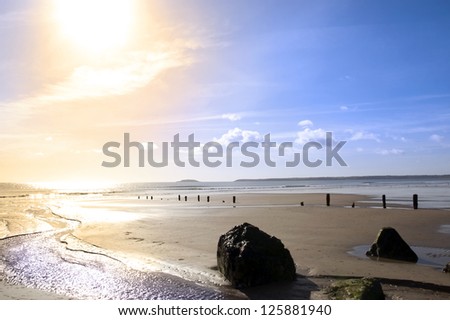 wave breakers at sunset on a golden beach in youghal county cork ireland