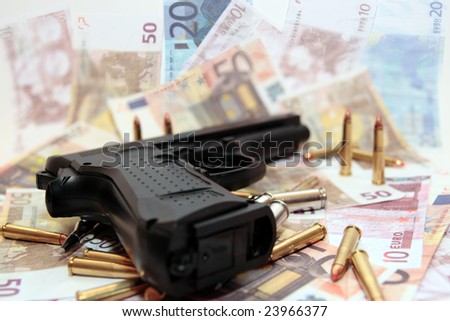 gun bullets and money showing a dangerous side to life