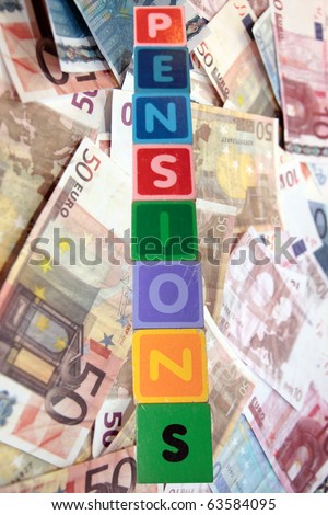toy letters that spell pensions against a cash background with clipping path