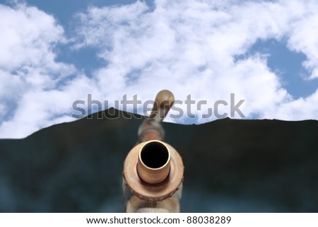 concept for clean mountain spring water with an outdoor water tap against a blue cloudy sky