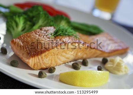 Golden delicious salmon steak with broccoli, asparagus, red pepper, capers, mayo and lemon