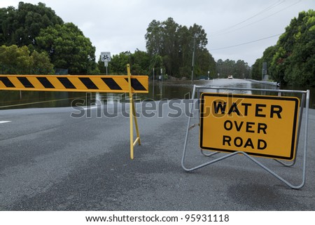 Flooded australian road with road block