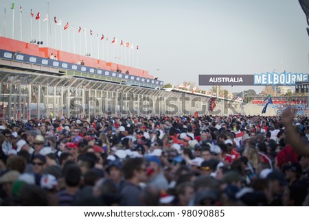 MELBOURNE, AUSTRALIA - MARCH 18: The crowd floods the circuit to watch the podium and results of the 2012 Qantas Australian Grand Prix on March 18, 2012 in Melbourne, Australia