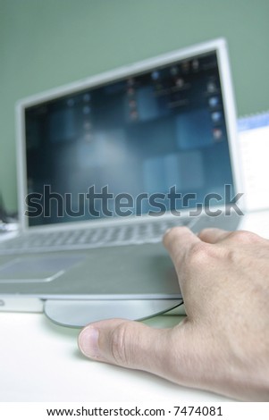 Man placing cd in laptop
