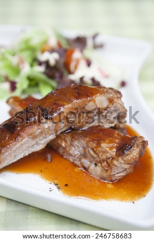 Pork rib stack with red sauce with salad,close up