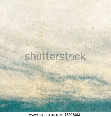 clouds on a textured vintage paper background, with grunge stains