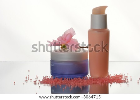 Cosmetic set: lotion bottles with cream, salt and flower
