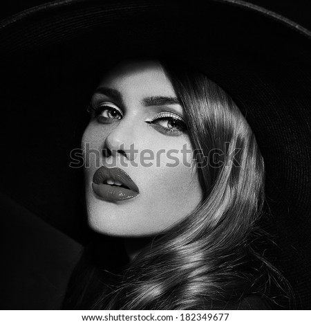 High fashion look.glamor closeup portrait of beautiful sexy stylish  Caucasian young woman model with bright makeup with perfect clean skin in big black hat