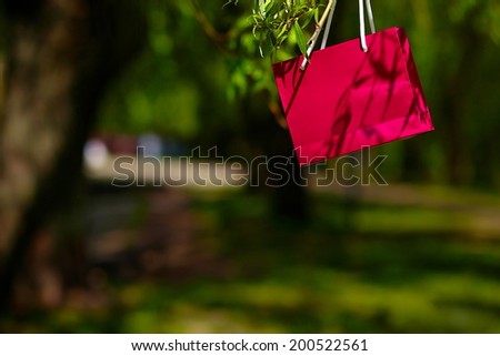 bright colorful red pink bag hanging in the park