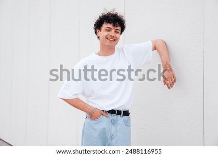 Similar – Image, Stock Photo Smiling curly haired man listening to music in headphones