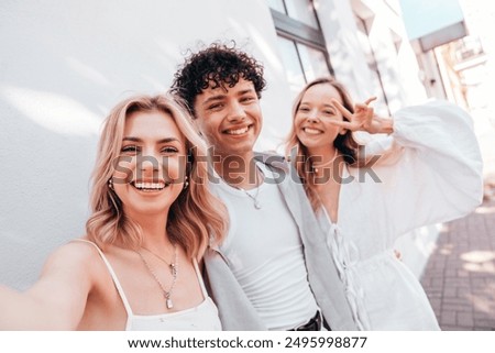 Similar – Image, Stock Photo Three girlfriends having fun taking a selfie