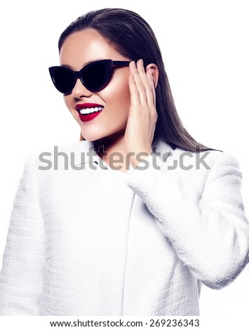 High fashion look.glamor closeup portrait of beautiful sexy smiling stylish brunette young woman model with bright makeup with red lips in white coat jacket in sunglasses
