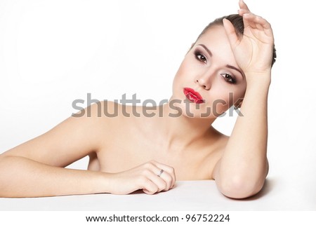 portrait of sexy sitting caucasian young woman model with glamour red lips,bright makeup, eye arrow makeup, purity complexion. Perfect clean skin