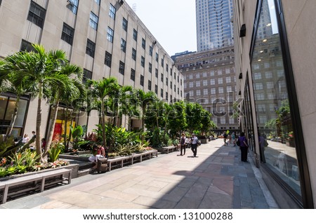 NEW YORK CITY - JULY 12: Walkway with palm trees near Rockefeller Center on July 12, 2012 in New York. Rockefeller Center is a complex of 19 commercial buildings covering 22 acres.