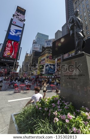 NEW YORK CITY - JULY 12: People sit in outdoor cafe at Times Square on July 12, 2012 in New York. Times Square is a major commercial intersection in Manhattan at the junction of Broadway and 7th Ave.