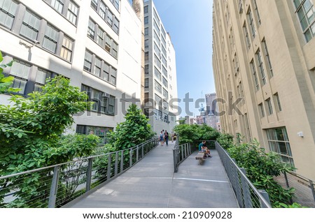 NEW YORK CITY - JULY 22: People walk along the High Line Park on July 22, 2014. The High Line is a popular linear park built on the elevated former New York Central Railroad spur in Manhattan.