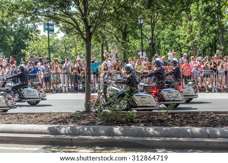 NEW YORK - JULY 10: Police officers drive motorcycles during the  parade on July 10, 2015 in NYC. The parade has been organized to celebrate the U.S. women\'s soccer team\'s World Cup final win.