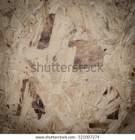 Recycled compressed wood particle board background, texture of oriented strand board (OSB)