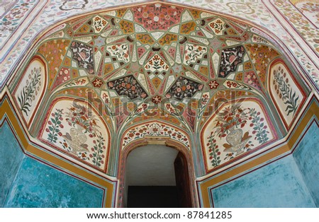 Detail of painting decoration on wall and ceiling at Amber Fort, India