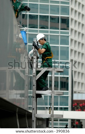 worker on the side of a building in central district hong kong