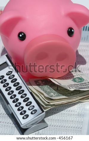 A pink piggy bank, american dollars and a calculator on a financial data background representing savings and investments