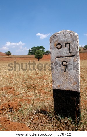 Distance marker on the side of a rural road in Burma (Myanmar)