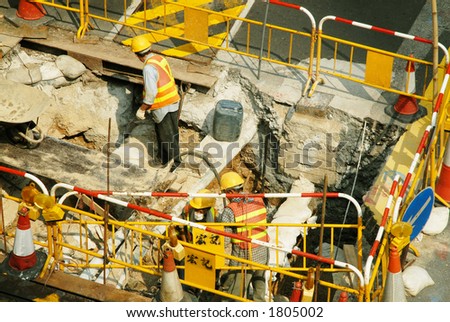 Team of road workers at a site along the street in Central district, Hong Kong, China SAR