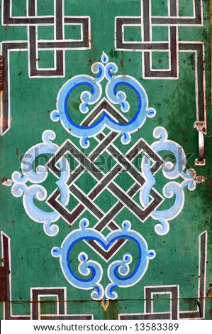 Buddhist symbols and endless knot design painted on the door of a ger (yurt) in Mongolia