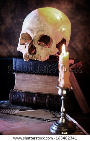 human skull and an old book. search of knowledge concept