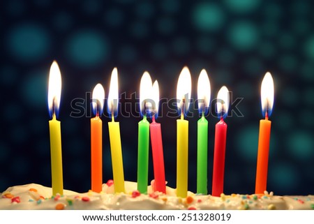 Nine lit birthday candles close up, shallow dof