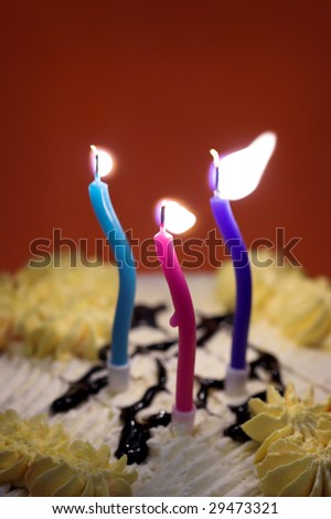three lit birthday candles close up
