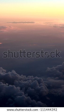 Photo of puffy clouds and blue sky from above the clouds.