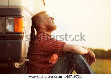 Bearded truck driver takes a break from work