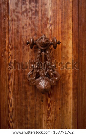 Ancient rarity doorhandle on a wooden door