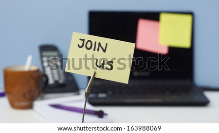 Join us written on a memo in a business office