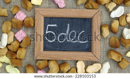 A chalkboard and a pile of Pepernoten, typical Dutch treat for Sinterklaas on 5 december