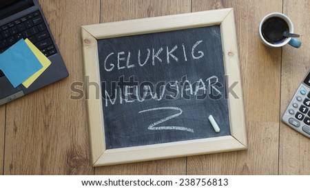 Happy new year in Dutch written on a chalkboard at the office