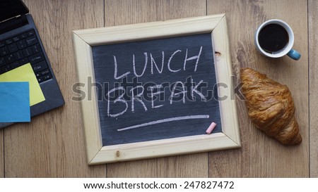 Lunch break written on a chalkboard next to a breakfast at the office