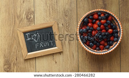 I love fruit written on a chalkboard next to berries and strawberries