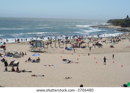 A lifeguard tower and people on the beach in Santa Cruz, CA