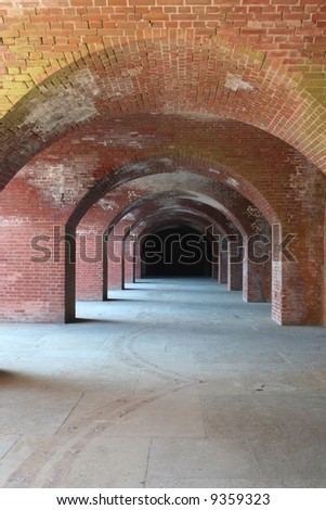 Looking down a hallway with brick arches in Fort Point, San Francisco.