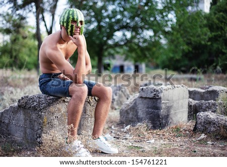 Photo of the young soldier with a water-melon on a head