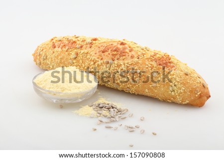 Appetizing fresh soft long loaf with cheese of a house batch strewed by sunflower sunflower seeds
