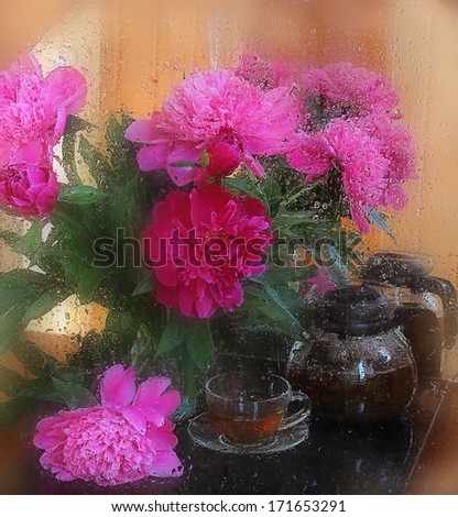 Still-life with fragrant fresh tea and a magnificent bouquet of peonies, a beautiful bouquet of peonies and fragrant tea in a transparent glass teapot