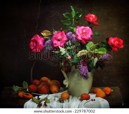 Still-life with a bright bouquet and fresh peaches, juicy ripe peaches and a magnificent bouquet from gentle roses and bird cherry branches