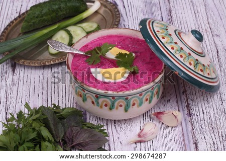 Beetroot soup - cold soup with a beet and egg submitted to a soup tureen, bread with garlic and a basil