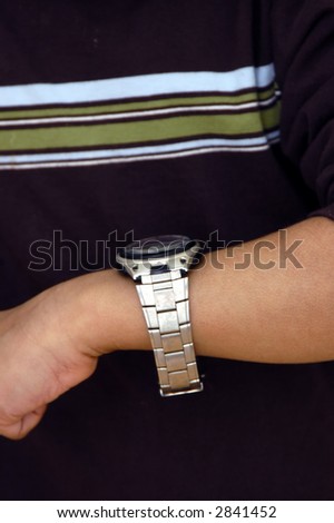 A kid looking at his wrist watch