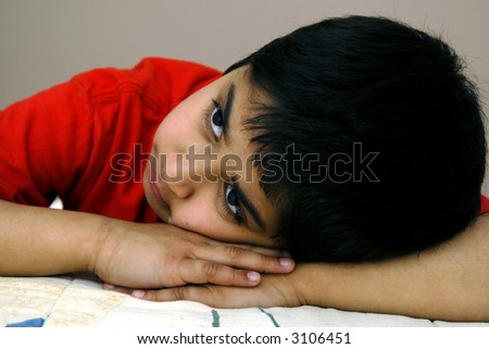 A handsome young boy dreaming about his future