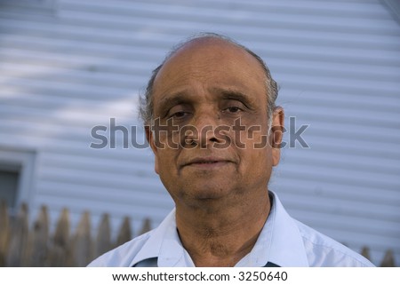 An old indian man smiling in the summer sun
